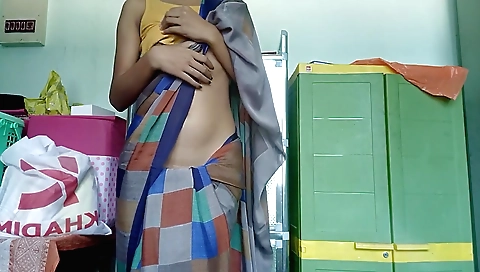 College girl in a red dress and saree with long hair plays a laptop