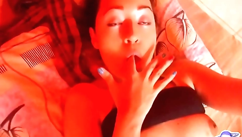 Busty brunette with a beautiful face plays with her pussy