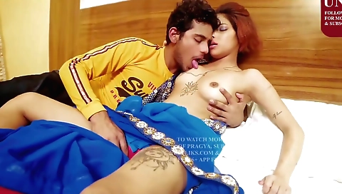 A red head with tattooed body is having a great time with her partner