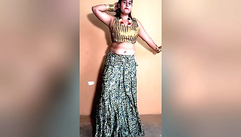 Indian woman in white dress and pink heels doing a dance