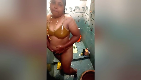 Sexy brunette girl is in the bathroom taking a shower