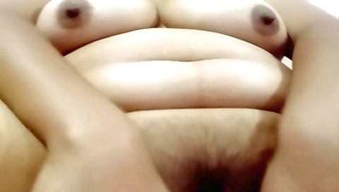 Busty brunette with a hairy pussy gets naked and masturbate