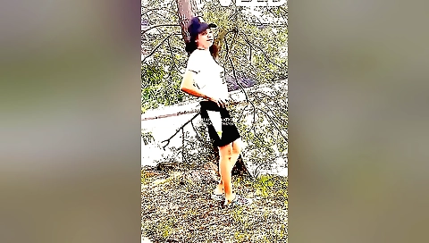 Hot brunette with a black hair and white shirt enjoys park outdoors